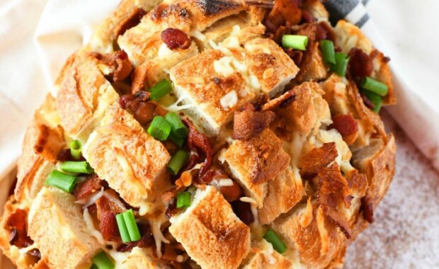 sausage pull apart bread, dish towel on white and brown background