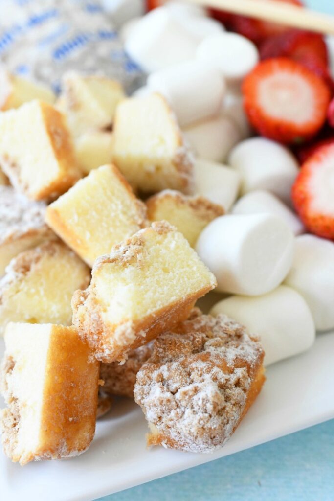 kake cubes, marshmallows, strawberries on plate