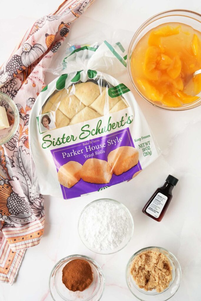 Sister Schubert Peach Roll Ingredients on a white surface with a pink, floral napkin.