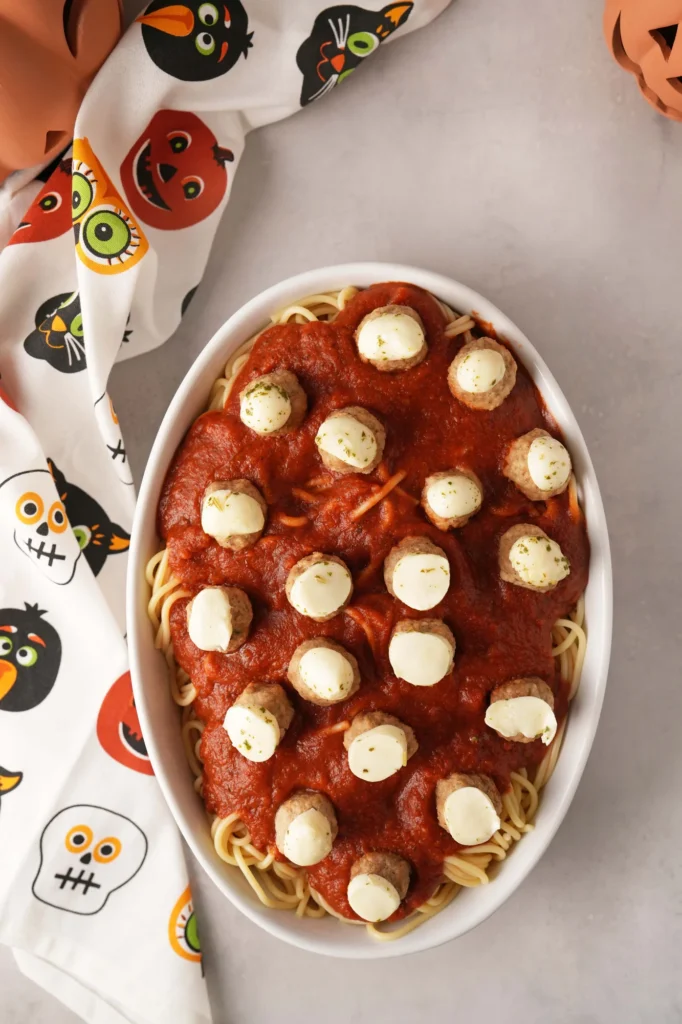Spaghetti topped with Halloween eyeball meatballs.